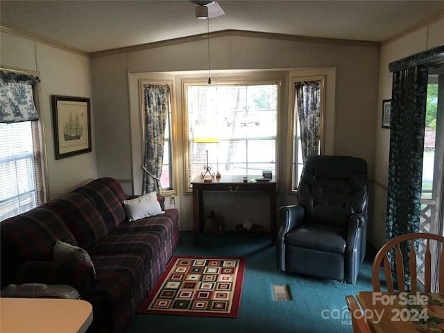 carpeted living area featuring a wealth of natural light, vaulted ceiling, and crown molding