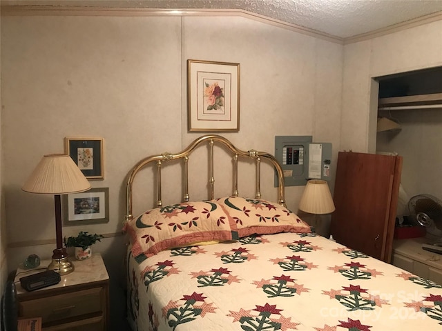 bedroom featuring ornamental molding, a closet, and a textured ceiling