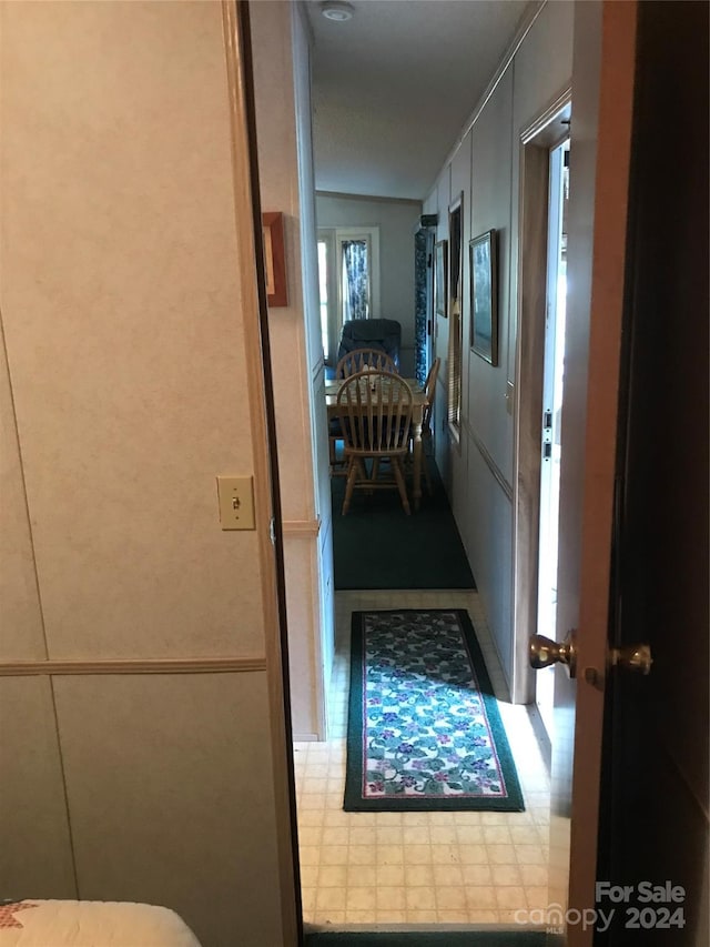 hall with tile patterned floors