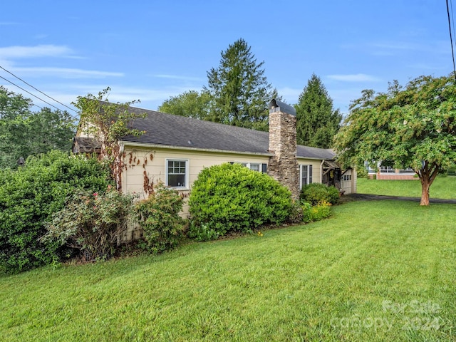 view of side of home featuring a yard