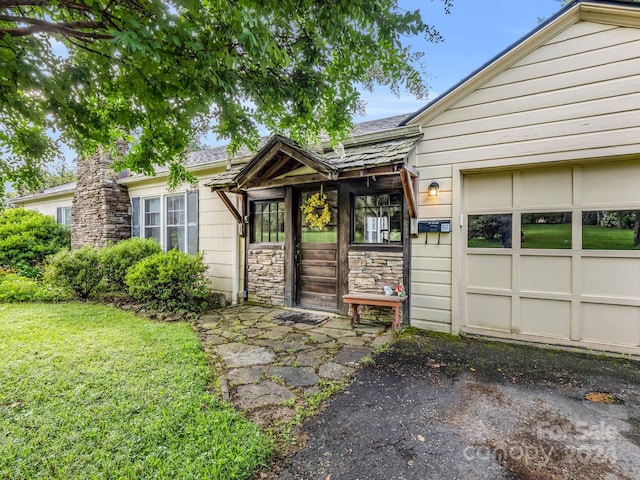 property entrance with a yard