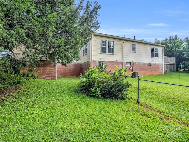 rear view of property featuring a lawn