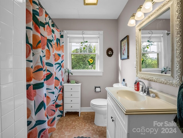 bathroom with tile patterned floors, vanity, and toilet