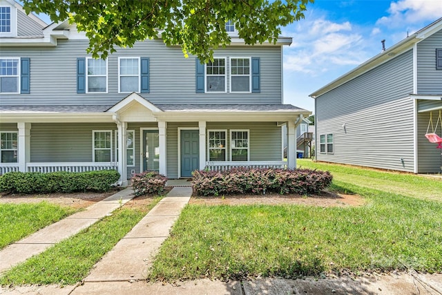 multi unit property featuring a front lawn and a porch