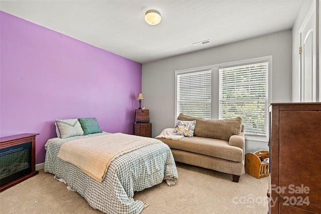 bedroom featuring light carpet