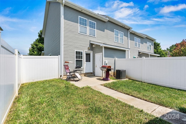 back of house with a patio, central AC unit, and a lawn