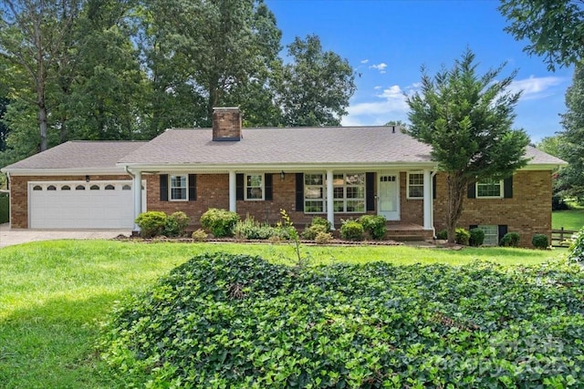 ranch-style home featuring a garage and a front lawn