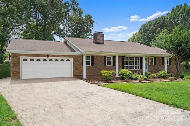 ranch-style house featuring a garage and a front yard