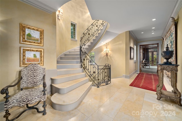 foyer with stairs, ornamental molding, baseboards, and recessed lighting