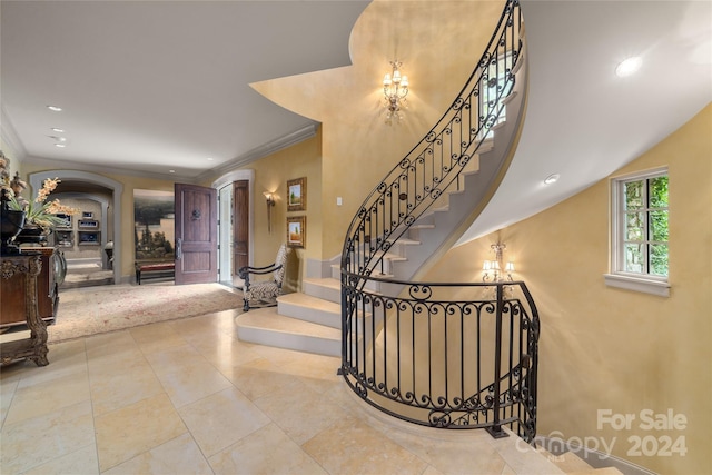 foyer featuring light tile patterned floors, stairs, ornamental molding, and recessed lighting