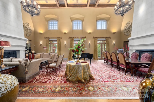 living area with a wealth of natural light, beam ceiling, a fireplace, and an inviting chandelier