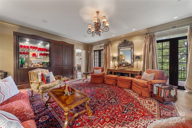 sitting room featuring light wood-style flooring, recessed lighting, ornamental molding, french doors, and an inviting chandelier