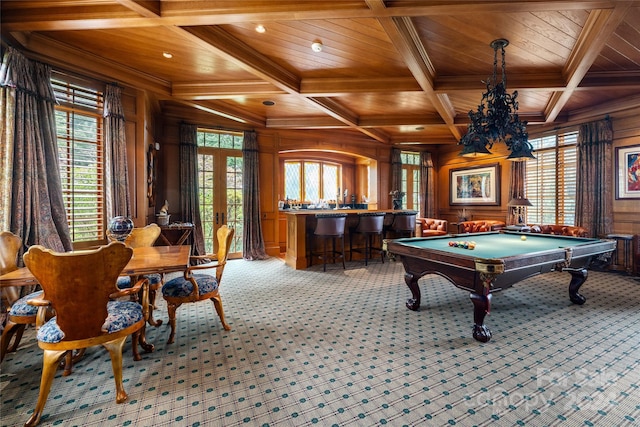 game room featuring coffered ceiling, light colored carpet, wood ceiling, and wooden walls