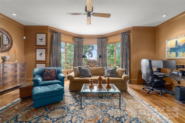 living area with baseboards, a ceiling fan, crown molding, and wood finished floors