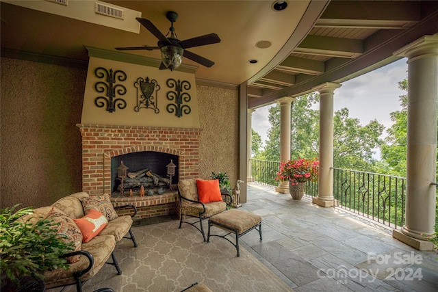 view of patio with a brick fireplace, visible vents, and ceiling fan