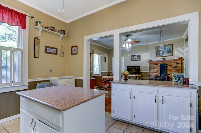 kitchen with ceiling fan, white cabinets, and plenty of natural light