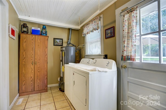 washroom with light tile patterned floors, crown molding, washer and clothes dryer, and water heater