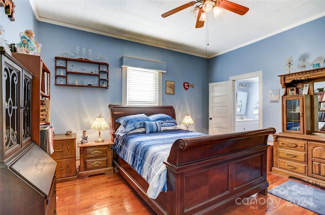 bedroom with light hardwood / wood-style floors, crown molding, ceiling fan, and ensuite bath