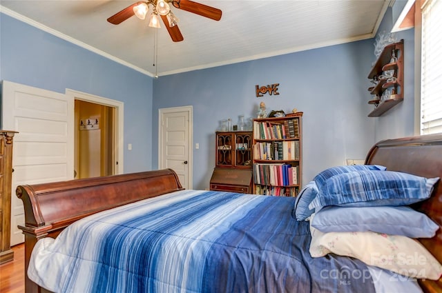 bedroom featuring ceiling fan, crown molding, and hardwood / wood-style flooring