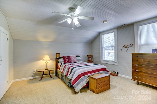 bedroom with ceiling fan, vaulted ceiling, and light colored carpet