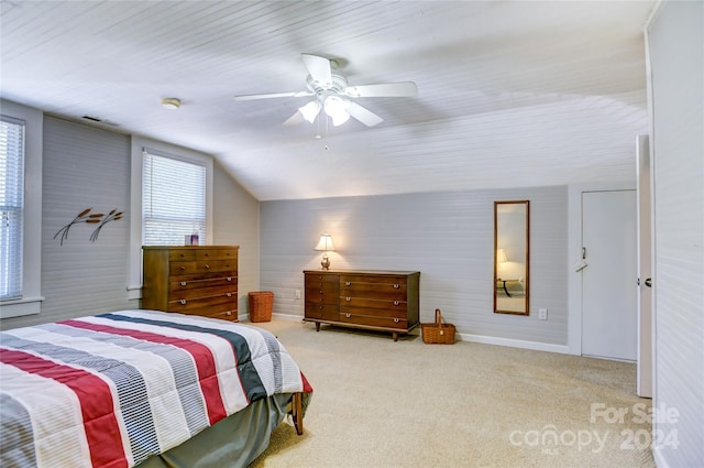 carpeted bedroom with ceiling fan and vaulted ceiling