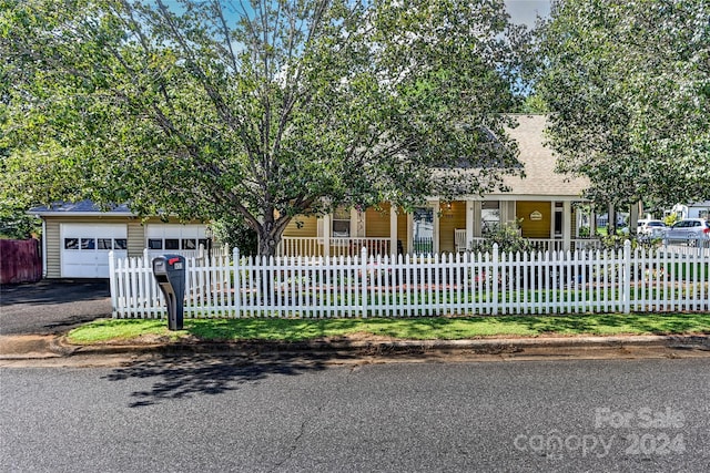 view of front of home with covered porch and a garage