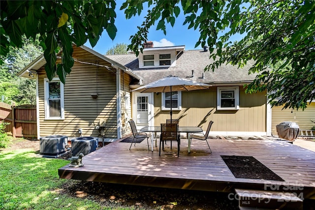 back of house featuring cooling unit and a wooden deck