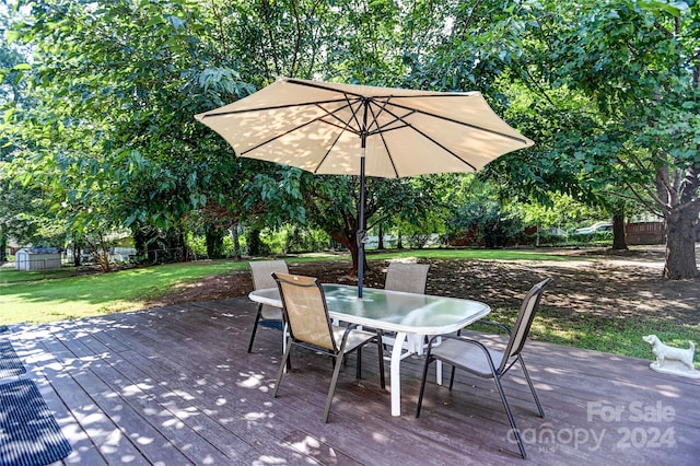 wooden terrace featuring a lawn