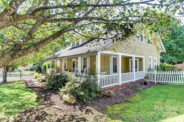 view of front of home with a porch and a front yard