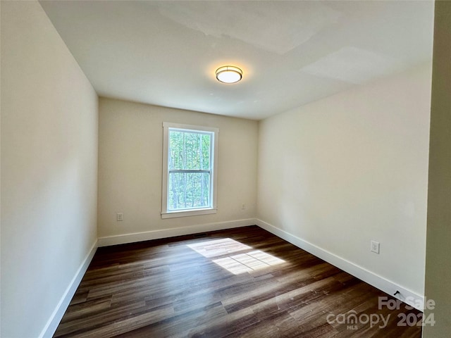 unfurnished room featuring dark hardwood / wood-style flooring