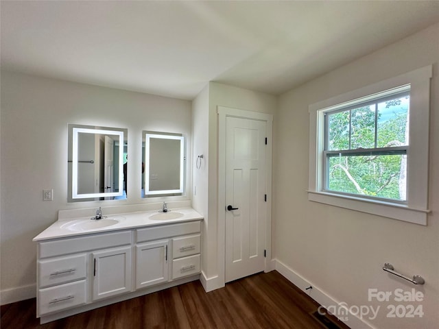 bathroom featuring double vanity and hardwood / wood-style flooring