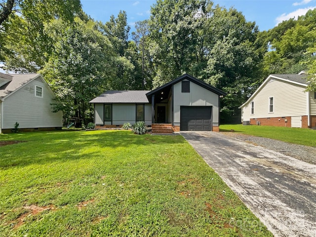 ranch-style home with a front lawn and a garage