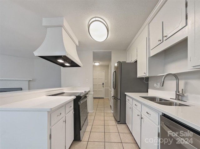 kitchen featuring premium range hood, light tile patterned flooring, sink, appliances with stainless steel finishes, and white cabinets