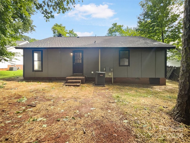 back of house with central AC unit