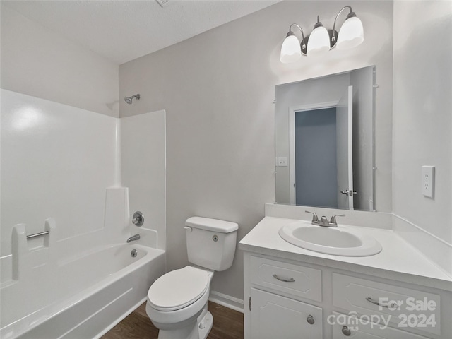 full bathroom with hardwood / wood-style flooring, vanity, toilet, and tub / shower combination