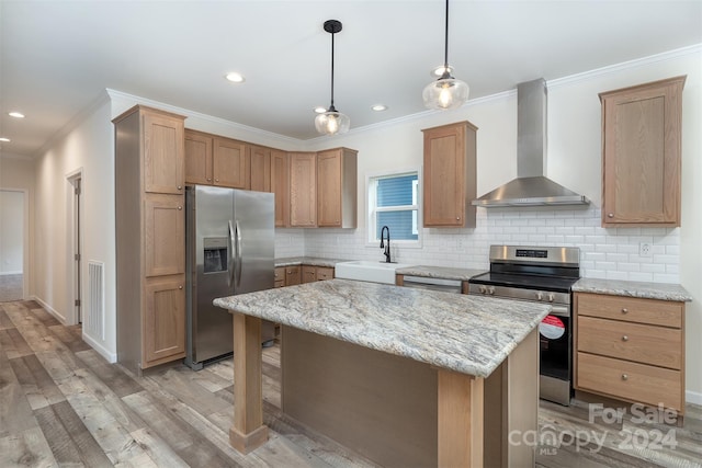 kitchen featuring appliances with stainless steel finishes, a center island, wall chimney exhaust hood, and tasteful backsplash