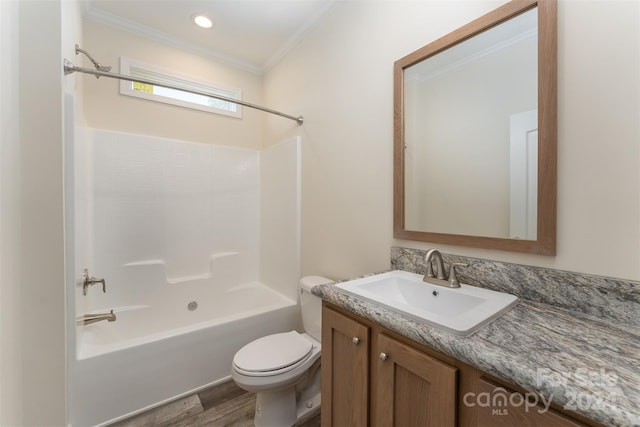 full bathroom featuring vanity, crown molding, bathtub / shower combination, toilet, and hardwood / wood-style flooring