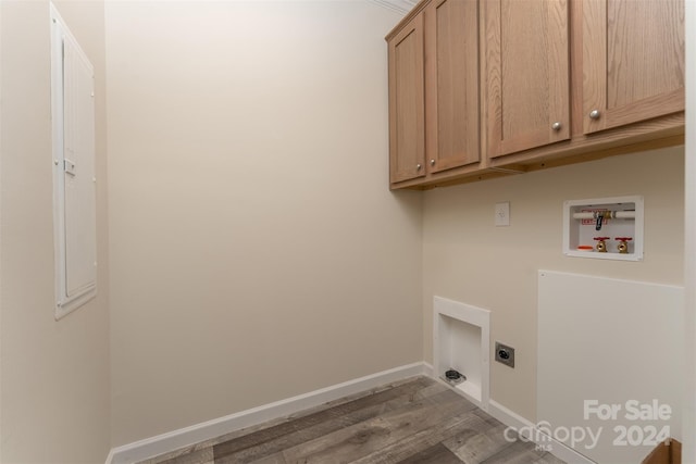 laundry area with hardwood / wood-style flooring, electric dryer hookup, washer hookup, and cabinets