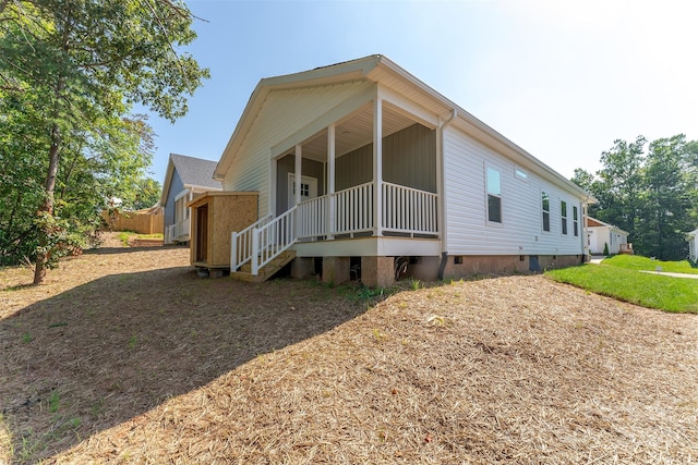 rear view of house featuring a porch