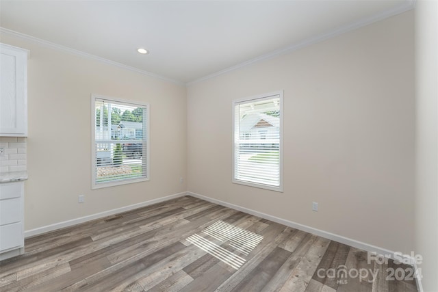 interior space with crown molding and light wood-type flooring