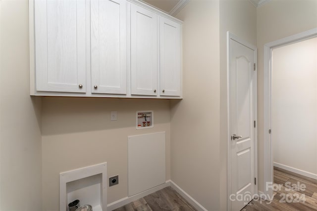 laundry area featuring crown molding, washer hookup, cabinets, hookup for an electric dryer, and hardwood / wood-style flooring