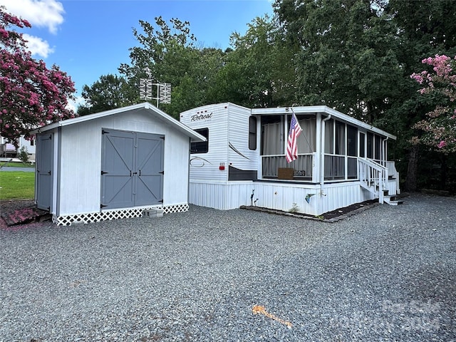 113 Hummingbird Cir, New London, NC 28127 - manufactured / mobile home featuring a storage shed, an outbuilding, and a sunroom
