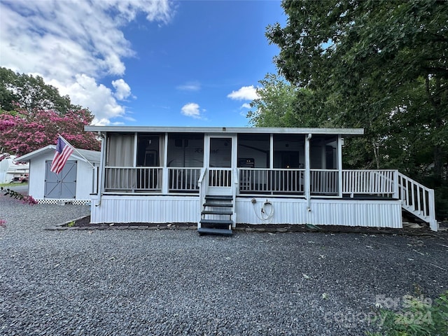 113 Hummingbird Cir, New London, NC 28127 - manufactured / mobile home featuring a sunroom, an outbuilding, and a storage unit