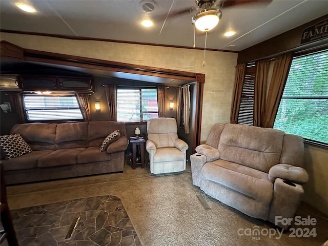 carpeted living room featuring ceiling fan