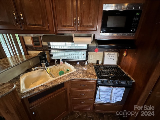 113 Hummingbird Cir, New London, NC 28127 - kitchen featuring a sink, dark stone counters, backsplash, and black appliances