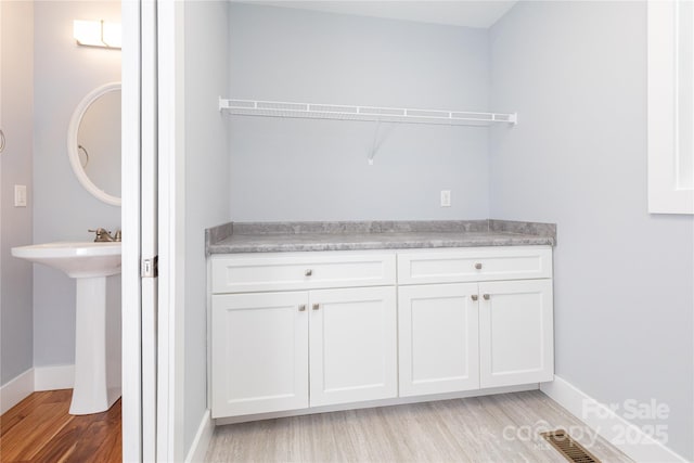 bathroom featuring wood-type flooring