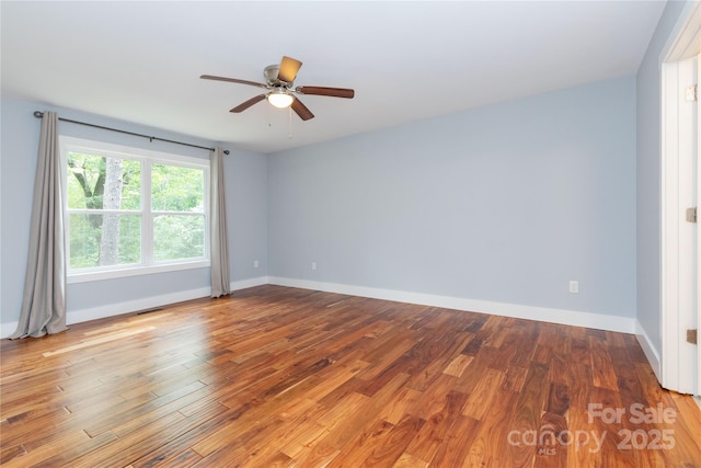 spare room featuring ceiling fan and hardwood / wood-style flooring