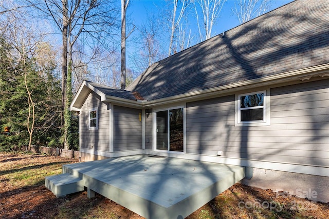 rear view of property featuring a wooden deck