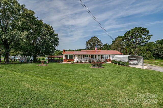 ranch-style house featuring a front yard and a carport