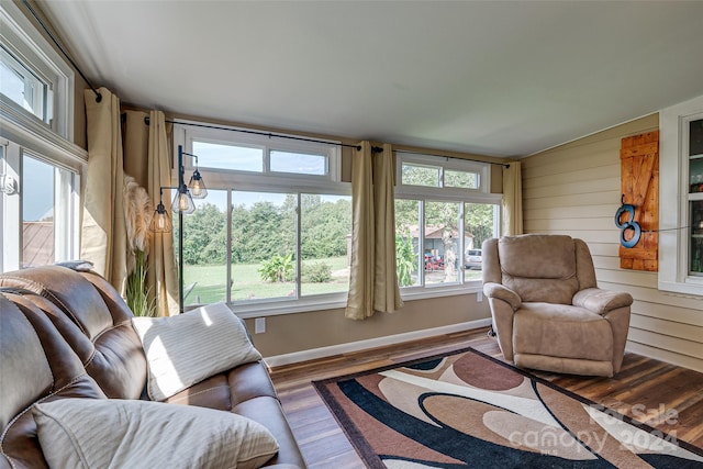 interior space with wood walls, baseboards, and wood finished floors